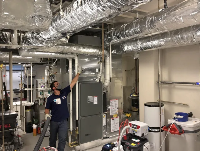 Concord Air Duct Cleaning specialist performing thorough furnace duct cleaning in a Concord residence